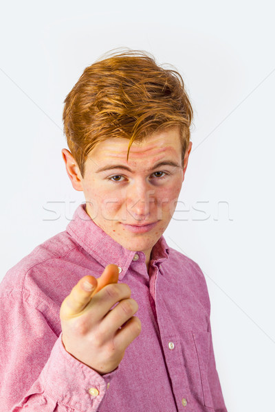 portrait of attractive laughing smiling boy in puberty pointing  Stock photo © meinzahn
