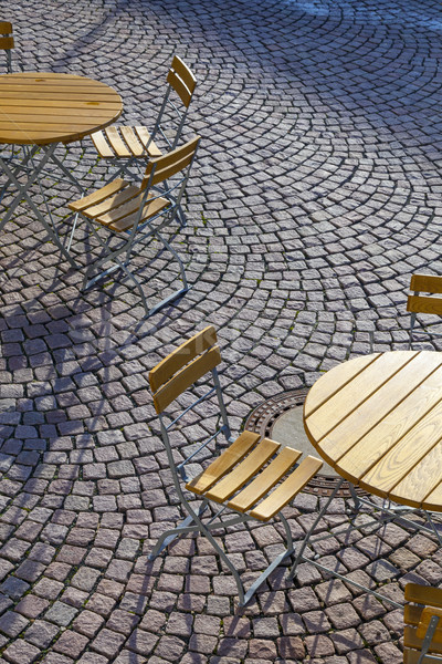 Outdoor German cafe seating with round tables and wooden   chair Stock photo © meinzahn