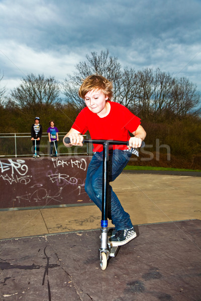 Boy going airborne with a scooter Stock photo © meinzahn