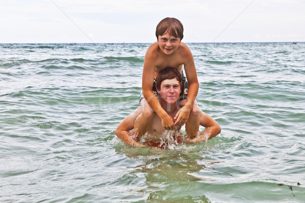 boys having fun in the beautiful clear sea Stock photo © meinzahn