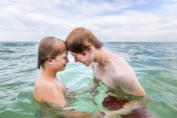 boys having fun in the clear sea  Stock photo © meinzahn