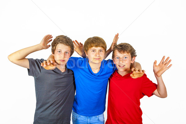 Stock photo: three happy joyful friends in blue, red and black