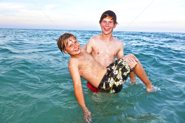 brother holds his younger brother in arms  Stock photo © meinzahn