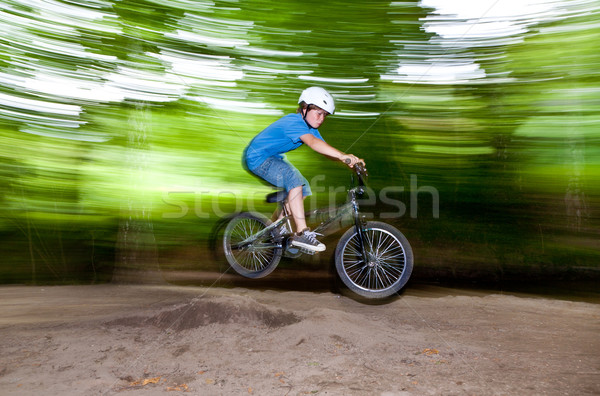 child has fun jumping with the bike over a ramp  Stock photo © meinzahn