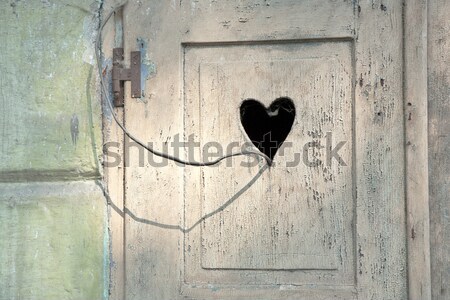 old wooden door with a carved romantic heart Stock photo © meinzahn
