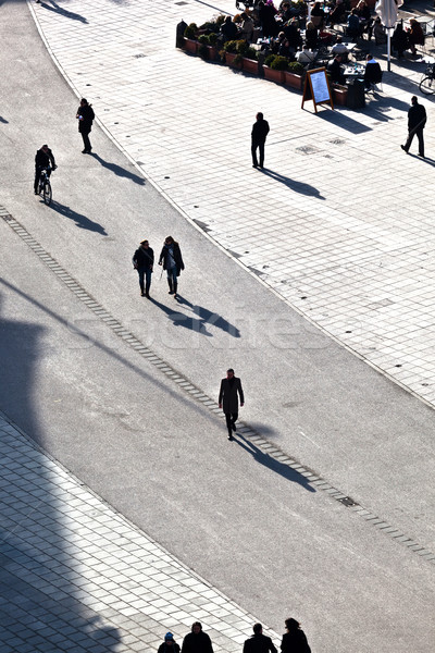 Pessoas caminhada rua longo sombras edifício Foto stock © meinzahn