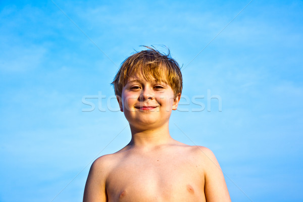 Stock photo: happy smiling young boy with background blue sky