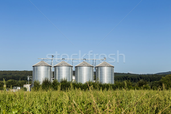 four silver silos in field under   blue sky Stock photo © meinzahn