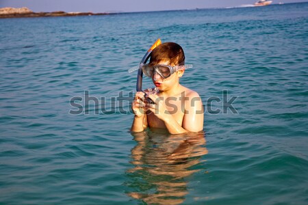 boy is enjoying the clear warm water at the beautiful beach but  Stock photo © meinzahn