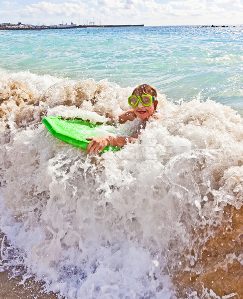 boy has fun with the surfboard Stock photo © meinzahn