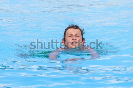 boy enjoys swimming in the pool Stock photo © meinzahn