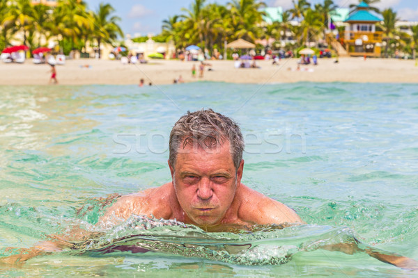 man has fun swimming in the ocean Stock photo © meinzahn