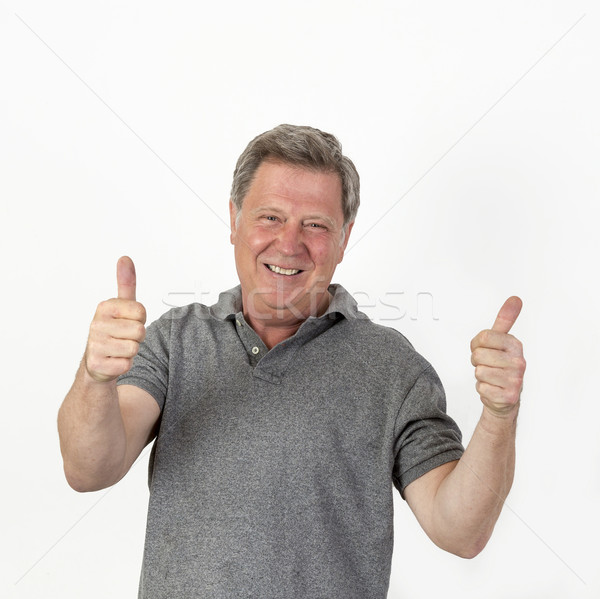 smiling mature man with grey polo shirt Stock photo © meinzahn