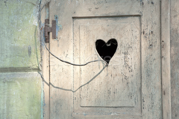 old wooden door with a carved romantic heart Stock photo © meinzahn