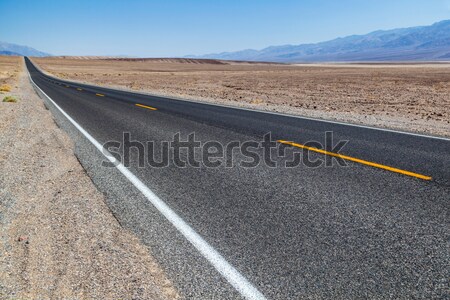 Death Valley road straight across the desert to the mountains in Stock photo © meinzahn