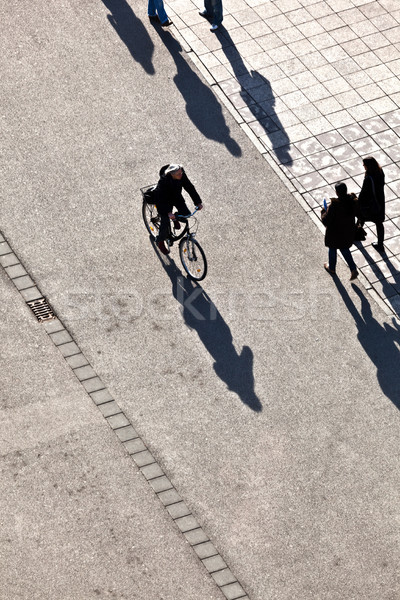 people walking at the street with long shadows Stock photo © meinzahn