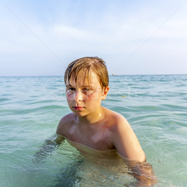 angry young boy swims in the clear warm saltwater Stock photo © meinzahn