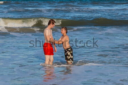 Stock photo: brothers playing together in the pool