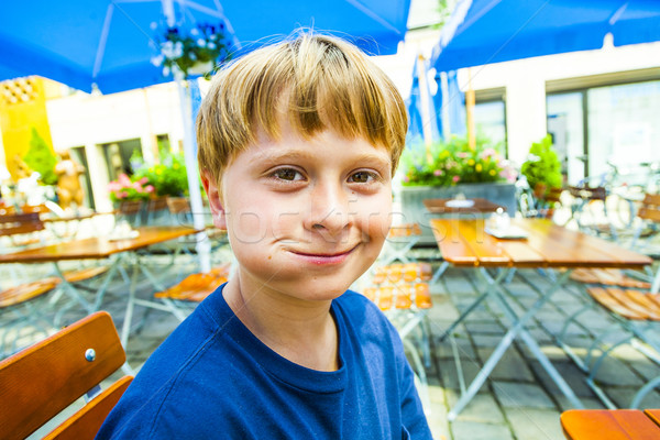 happy smiling child enjoys eating Stock photo © meinzahn