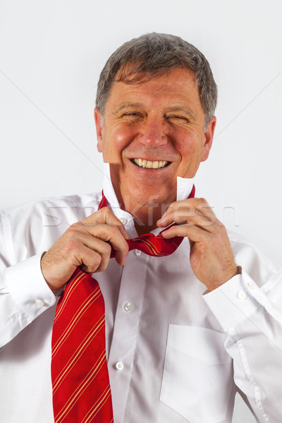 business man binding his tie  Stock photo © meinzahn