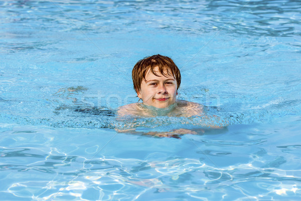 Stock photo: boy swimming in the pool