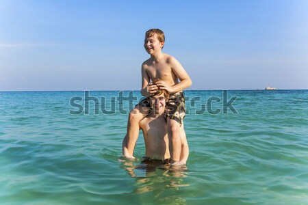 brothers enjoy the clear warm water and playpickaback Stock photo © meinzahn