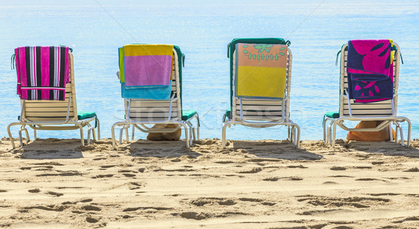 A row of three beach chairs overlooking the sea view  Stock photo © meinzahn
