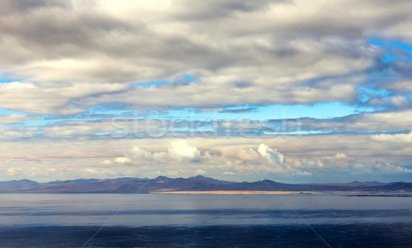 aerial of Arrecife with volcanoes in clouds Stock photo © meinzahn