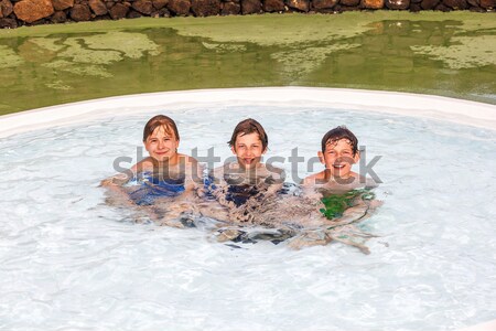 children are swimming and using an air-matress for relaxing at t Stock photo © meinzahn