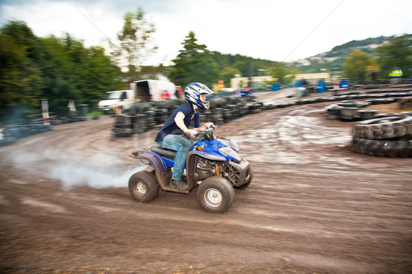 young boy is faszinated by quad driving and enjoyes is, his face Stock photo © meinzahn