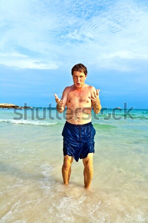 man enjoys walking along the beach Stock photo © meinzahn