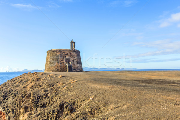 Small castle Castillo de las Coloradas on cliff in Playa Blanca Stock photo © meinzahn