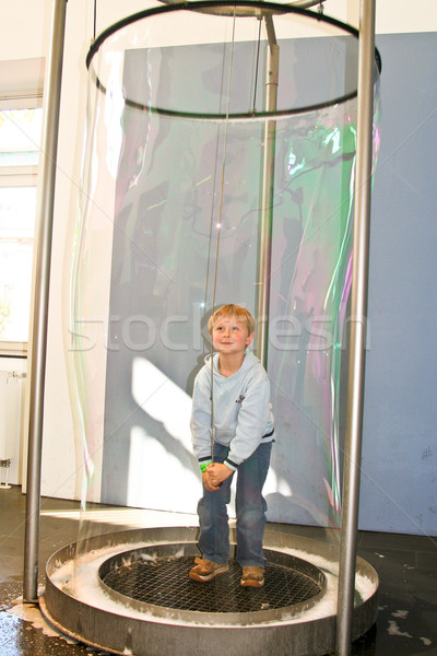 child has fun in a huge bubble machine Stock photo © meinzahn