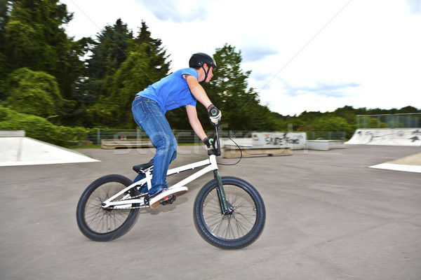 boy has fun with his BMX at the skatepark Stock photo © meinzahn