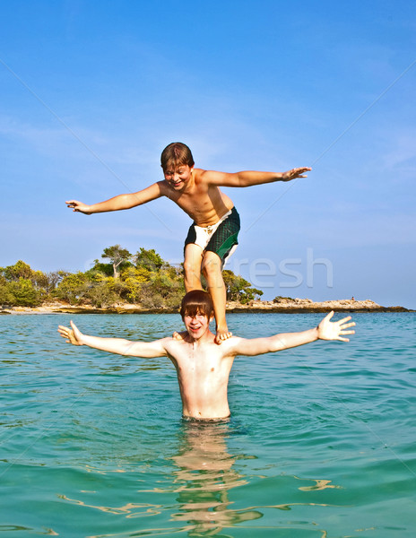 brothers are playing together in a beautiful sea with crystal cl Stock photo © meinzahn