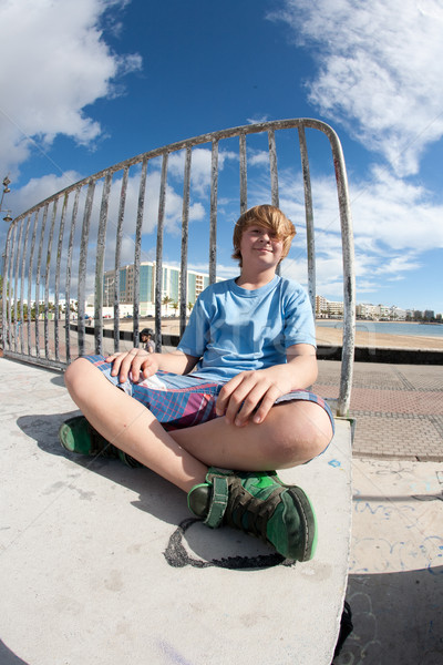 cute boy sitting at the skate park  Stock photo © meinzahn