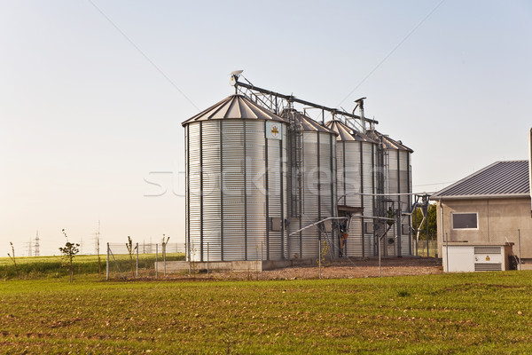 silver shining silo with acre in landscape Stock photo © meinzahn