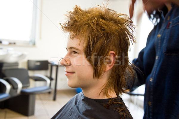 smiling young boy with red hair at the hairdresser Stock photo © meinzahn