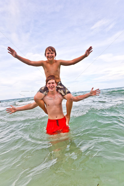 brothers have fun in the beautiful clear sea Stock photo © meinzahn