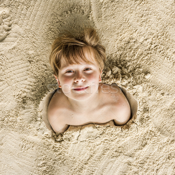 happy young boy covered by fine sand Stock photo © meinzahn