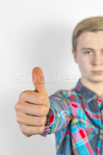 boy shows thumbs up sign, focus on hand Stock photo © meinzahn