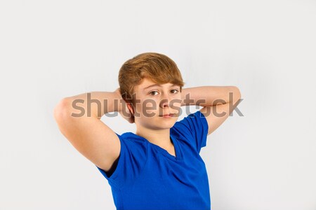 cool boy keeps his arms behind his head  Stock photo © meinzahn