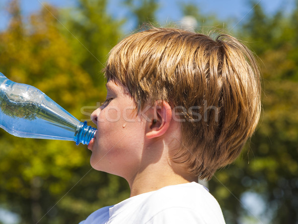 young boy drinks water out of a bottle  Stock photo © meinzahn