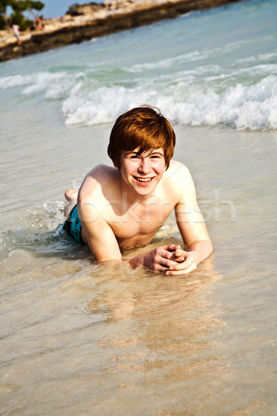 happy boy with red hair is enjoying the beautiful beach Stock photo © meinzahn