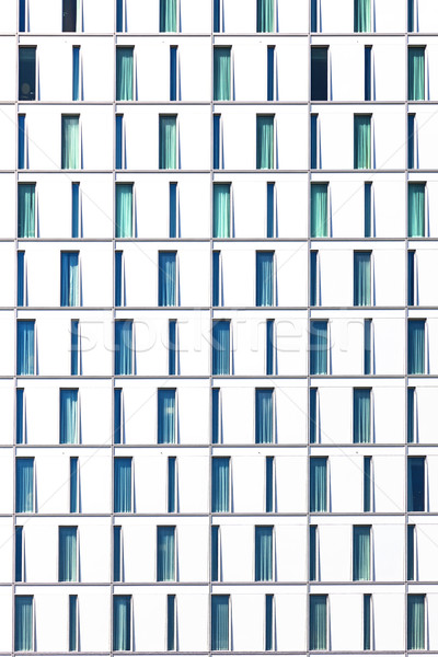 facade of skyscraper with windows structured in rows with differ Stock photo © meinzahn