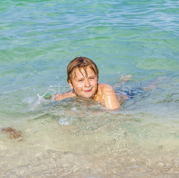boy enjoys the clear water in the ocean Stock photo © meinzahn