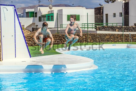 three boys swimming in the pool Stock photo © meinzahn