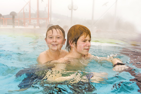 brothers are swimming in the outside area of a thermic pool in W Stock photo © meinzahn