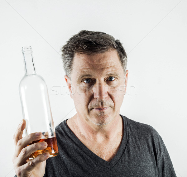 человека питьевой алкоголя из бутылку лице Сток-фото © meinzahn