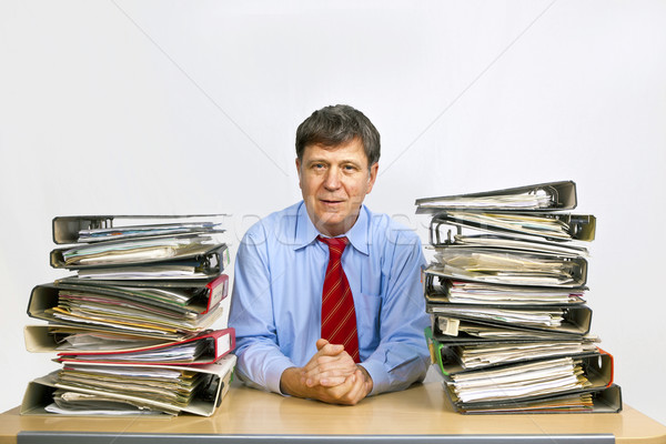 man studies folder with files at his desk in the office Stock photo © meinzahn